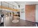 Bright and airy living area featuring a brick accent wall and open access to the kitchen at 375 S University Blvd, Denver, CO 80209