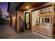 Brick home with a large open door to a covered patio showing the interior with compass inlay in the tile flooring at 375 S University Blvd, Denver, CO 80209