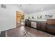 Upper landing wet bar area with stainless steel appliances, plenty of storage, and access to another room at 375 S University Blvd, Denver, CO 80209