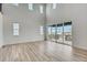 Bright and airy great room featuring high ceilings, large windows, and hardwood floors at 3994 Breakcamp Ct, Castle Rock, CO 80108