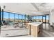 Bright lounge area with expansive windows, kitchen island, and fireplace at 3994 Breakcamp Ct, Castle Rock, CO 80108
