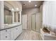 Elegant bathroom with dual sinks, modern vanity, framed mirrors and glass-enclosed shower at 1185 W 140Th Dr, Westminster, CO 80023