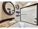 Bathroom with granite countertops, decorative mirror, and a shower-tub combination at 1185 W 140Th Dr, Westminster, CO 80023