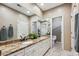 Bathroom featuring double vanity, granite countertop, and access to a private toilet at 1185 W 140Th Dr, Westminster, CO 80023