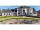 Stately home exterior with a large front lawn and elegant stone accents and circular driveway at 1185 W 140Th Dr, Westminster, CO 80023