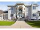 Elegant home exterior with an arched entryway, stately columns, and manicured landscaping at 1185 W 140Th Dr, Westminster, CO 80023