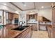 Gourmet kitchen with granite countertops, double sinks, and custom cabinetry at 1185 W 140Th Dr, Westminster, CO 80023