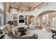 Expansive living room with high ceilings, a fireplace, built-ins, and a statement staircase at 1185 W 140Th Dr, Westminster, CO 80023