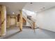 Interior view showcasing decorative columns, a staircase with carpet steps, and open spaces at 1185 W 140Th Dr, Westminster, CO 80023