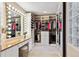 Bright walk-in closet featuring custom shelving, hanging racks, makeup vanity, and dressing area at 1185 W 140Th Dr, Westminster, CO 80023