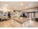 Kitchen featuring a large granite island, hardwood floors, and recessed lighting at 8502 Oak St, Arvada, CO 80005