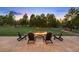 Beautiful backyard featuring a stone fire pit with chairs and a large grassy area at 6111 Huron Pl, Castle Rock, CO 80108