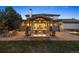 Covered patio with fire pit, comfortable seating, and stone pillars overlooking backyard at 6111 Huron Pl, Castle Rock, CO 80108