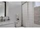 Clean bathroom with marble countertop vanity, white tiling, and shower with curtain at 6111 Huron Pl, Castle Rock, CO 80108