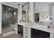 Spacious bathroom with double sink vanity, decorative mirrors, and a modern glass-enclosed shower at 6111 Huron Pl, Castle Rock, CO 80108