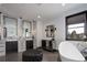 Bright bathroom with dual sink vanity, modern soaking tub, and sleek finishes throughout at 6111 Huron Pl, Castle Rock, CO 80108
