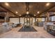 Spacious covered patio with stone fireplace, outdoor seating, and dining area for entertaining at 6111 Huron Pl, Castle Rock, CO 80108