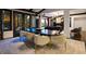 Modern dining room with large windows, stylish lighting, and seating for eight at 6111 Huron Pl, Castle Rock, CO 80108