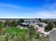 Expansive home showcasing a lush lawn, mature trees, and exterior stonework, with a serene, picturesque backdrop at 6111 Huron Pl, Castle Rock, CO 80108