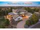 Stunning two-story home featuring a tile roof, well-manicured landscaping, and a charming outdoor living space with warm lighting at 6111 Huron Pl, Castle Rock, CO 80108