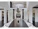 Grand foyer featuring a long dining table, a view of the staircase, and an elegant chandelier at 6111 Huron Pl, Castle Rock, CO 80108