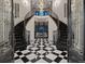 Grand foyer with a stunning curved staircase, a dazzling chandelier, and elegant black and white checkered marble flooring at 6111 Huron Pl, Castle Rock, CO 80108