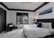 Serene bedroom with a plush bed, stylish armchair, and a large window offering views of the outdoors at 6111 Huron Pl, Castle Rock, CO 80108
