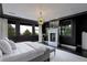 Luxurious main bedroom featuring a stylish fireplace, dark walls, and large windows offering picturesque outdoor views at 6111 Huron Pl, Castle Rock, CO 80108