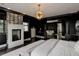 Spacious bedroom features dark walls, fireplace, and doorway to relaxing sitting room and ensuite bathroom at 6111 Huron Pl, Castle Rock, CO 80108