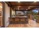 Beautiful outdoor kitchen with stone counters, bar seating, and modern appliances at 6111 Huron Pl, Castle Rock, CO 80108