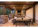Cozy outdoor living area with stone fireplace, comfortable seating, and stylish decor at 6111 Huron Pl, Castle Rock, CO 80108