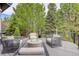 Stylish patio with modern seating arrangements centered around a cozy fire pit, surrounded by lush greenery at 6111 Huron Pl, Castle Rock, CO 80108