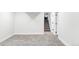 Finished basement room with gray carpet and access to stairs at 7348 S Lafayette W Cir, Littleton, CO 80122