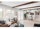 Open living room with kitchen views and wood beams at 7348 S Lafayette W Cir, Littleton, CO 80122