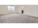 Large bedroom with gray carpet, neutral walls, and a view from the window at 11039 Snowdon St, Parker, CO 80134