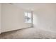 Cozy bedroom with neutral gray carpet, white walls, and a bright window at 11039 Snowdon St, Parker, CO 80134