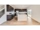 Modern kitchen with dark cabinets, stainless steel appliances, a kitchen island, and a sliding glass door at 11039 Snowdon St, Parker, CO 80134