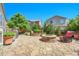 Spacious backyard with stone patio, built-in fire pit, and lush landscaping at 16043 Azalea Ave, Parker, CO 80134