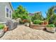 A backyard flagstone patio features planters, trees and a built in decorative brick surround planter at 16043 Azalea Ave, Parker, CO 80134
