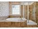 Bathroom boasts tub, tiled shower with glass doors, and window with bright natural light at 16043 Azalea Ave, Parker, CO 80134