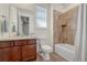 Cozy bathroom with wood cabinet, vanity sink, toilet and shower at 16043 Azalea Ave, Parker, CO 80134