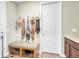 Cozy entryway with bench seating, decorative hooks for coats, and tiled floors at 16043 Azalea Ave, Parker, CO 80134