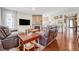 Cozy living room with a stone fireplace, plush leather seating, and hardwood floors provides a relaxing atmosphere at 16043 Azalea Ave, Parker, CO 80134