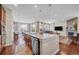 Open-concept kitchen and living room with a large island, stainless steel appliances, and comfortable seating at 16043 Azalea Ave, Parker, CO 80134