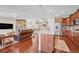 Open-concept living space with kitchen island, stainless steel appliances, and comfortable living room area at 16043 Azalea Ave, Parker, CO 80134
