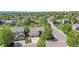 Expansive aerial view of a suburban home surrounded by mature trees in a peaceful neighborhood at 20591 E Weaver Ave, Aurora, CO 80016