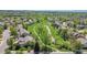 An aerial view of a home and neighborhood with lush green space and walking paths at 20591 E Weaver Ave, Aurora, CO 80016