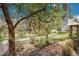 Charming backyard garden with a stone pathway, flowering trees, and views of the walking path at 20591 E Weaver Ave, Aurora, CO 80016