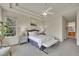 Bright bedroom with a neutral color palette, tray ceiling, and a large window at 20591 E Weaver Ave, Aurora, CO 80016