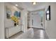 Welcoming foyer with neutral tile flooring, a modern console table, and bright natural light at 20591 E Weaver Ave, Aurora, CO 80016